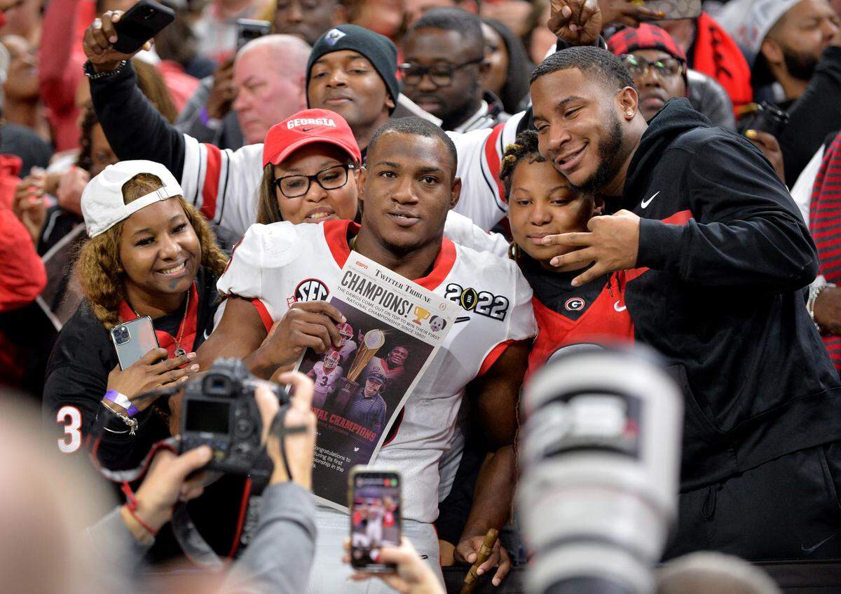 Georgia running back Zamir White (3) celebrates in the stands after the Bulldogs’ 33-18 win over Alabama in the College Football Playoff National Championship game Monday night.