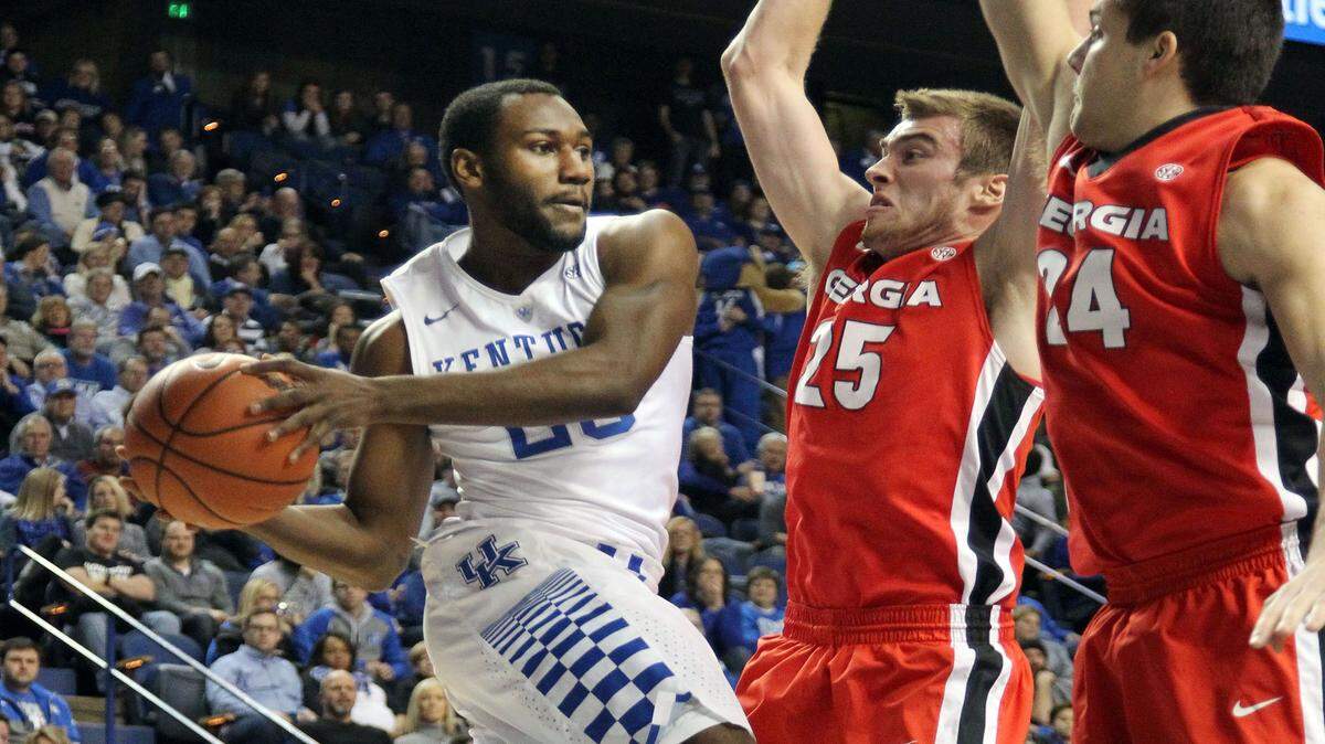 Kentucky's Dominique Hawkins, left, looks for an opening on Georgia's Kenny Paul Geno (25) and Houston Kessler (24) during the second half of Tuesday's game. Hawkins and the Wildcats cruised to a 82-48 win, handing the Bulldogs their second 34-point loss in conference play this season.