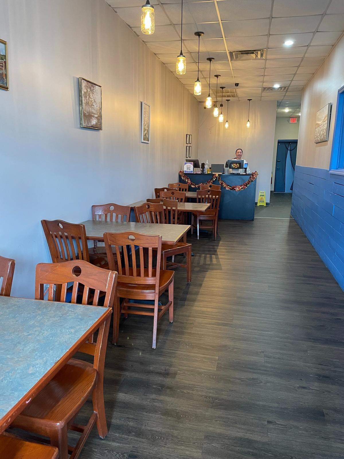 Geared mostly for takeout, the new Seafood Corner in Warner Robins offers four tables for four for dine-in, or to wait for an order to go. Co-owner Kayla Zhang is at the cash register in the background.