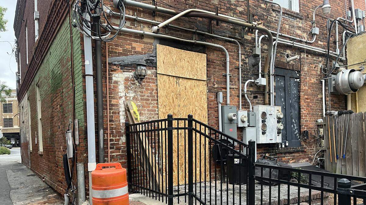 Fresh wood covered a back door after it was destroyed, and soot covered the black brick above it after a fire on Sept. 29, 2025, at 578 Southern Style Cuisine, a soul food restaurant in downtown Macon, Ga.