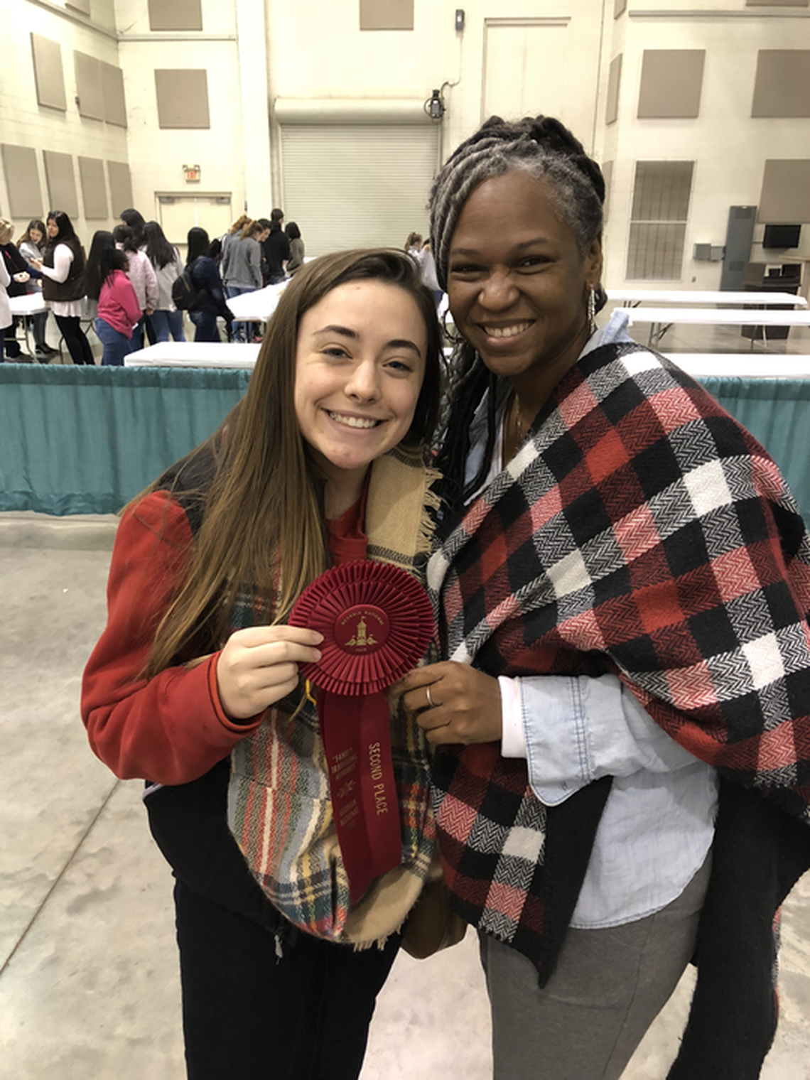 Erica Alcox, a former high school nutrition teacher in DeKalb County, poses with a student who won an award at the Georgia National Fair.