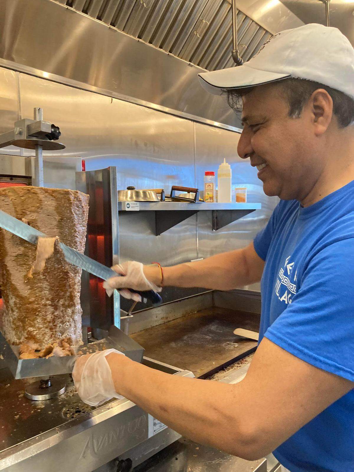 Nabor Gutierrez, chef, manager and owner Olympia Gyros in Warner Robins, carves meat off the gyro spit.