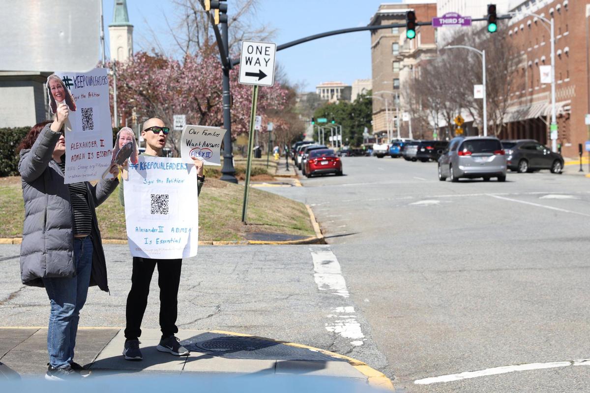Parents of an Alexander II Elementary School fifth grader Jessica Vance (left) and Joon Lee hold signs and chant while protesting the unexpected termination of the principal and assistant principal at Alexander II Elementary School on Friday, March 7, 2025, in front of the Bibb County Board of Education in downtown Macon, Georgia. A small but vocal group of parents and community members protested on Friday afternoon calling for the Bibb County school district to give answers as to why the Alexander II Elementary Schools principals’ contracts were not extended.