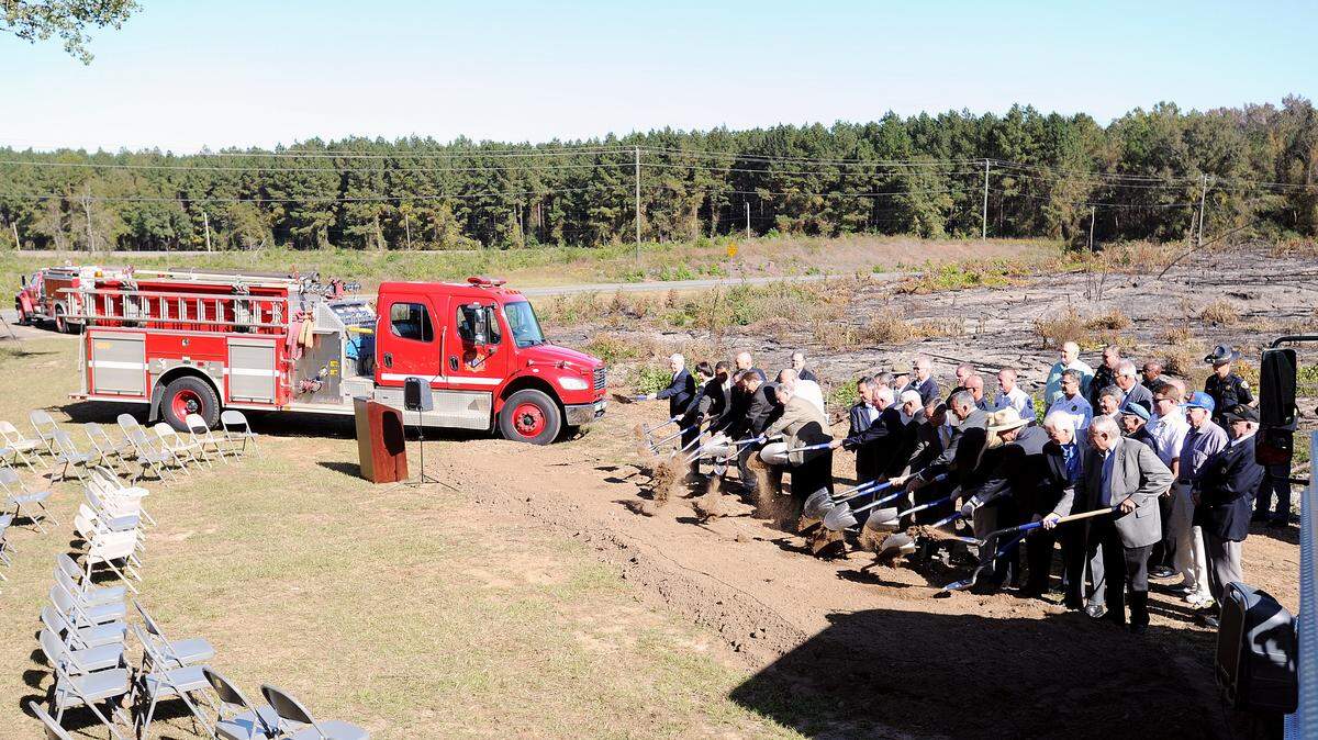 Officials toss shovels of dirt during a groundbreaking of Houston County Fire Department Station 6 located next to Perdue Farms on Hwy. 247 Spur.