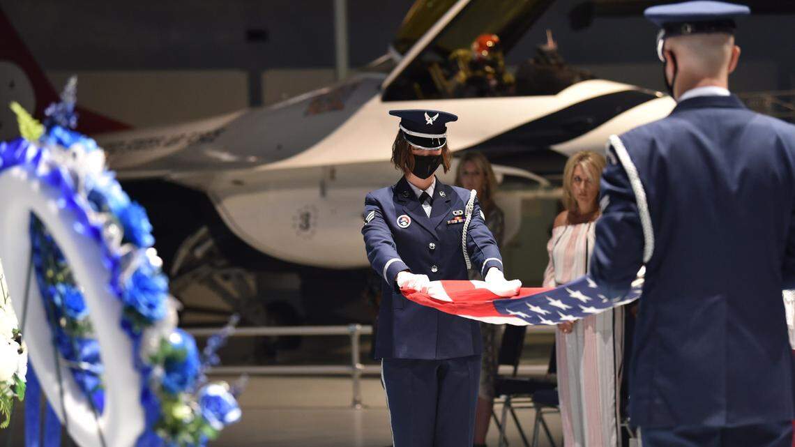 ROBINS AIR FORCE BASE, Ga. – Airman 1st Class Benjamin Campbell, right, and Senior Airman Mikayla Petersen, both with the Honor Guard at Robins Air Force Base, Georgia, perform a ceremonial flag folding during the Robins AFB Airman’s Memorial ceremony at the Museum of Aviation May 27, 2021. This was the 44th iteration of the memorial that has seen a total of 2,134 Team Robins members memorialized. (U.S. Air Force photo by Misuzu Allen)