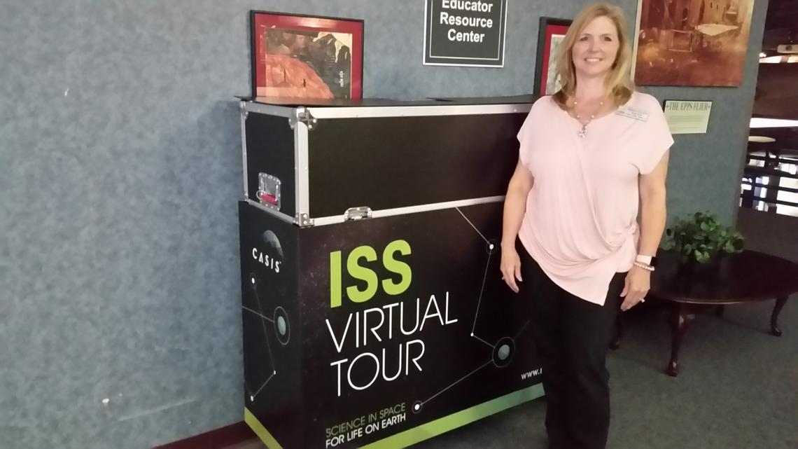 Melissa Spalding with the Museum of Aviation Education Department’s brand new, still-in-its crate, International Space Station Virtual Tour, which will be operational in the coming weeks.