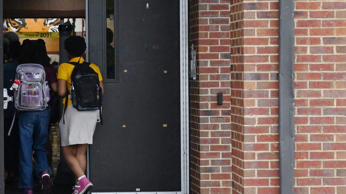 Students walk into Ballard Hudson Middle School for the first day of school on Monday, Aug. 4, 2025, in Macon, Georgia.