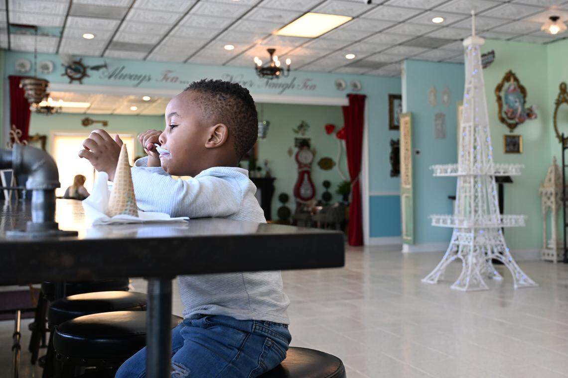 Cameron Askew, 3, of Warner Robins, eats ice cream inside of the new Mad Hatter Cafe & Confections in Warner Robins. He and his mother Myanna Askew were the first customers at the cafe and confectionery at 85 Ga. 247 across from Robins Air Force Base.