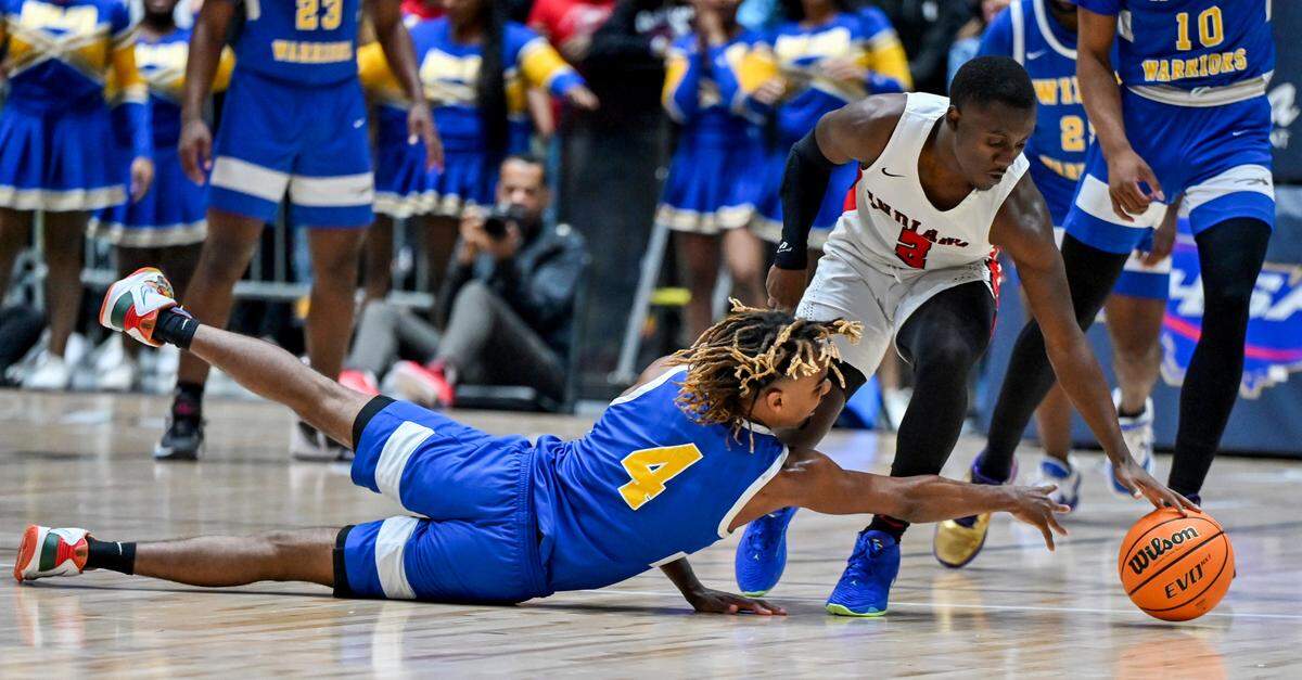 Wilkinson’s DeKarteyia Craig (4) dives for a loose ball during the Warriors’ GHSA 1A D-II championship against Charlton County Wednesday in Macon.