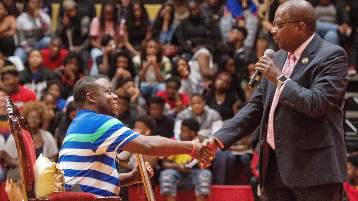 Superintendent Curtis Jones shakes hands with 2019 Bibb County School District Teacher of the Year Jarred Moore Wednesday during a surprise celebration at Northeast High School on Aug. 15. Jones himself was later given a high honor, being named Georgia Superintendent of the Year.
