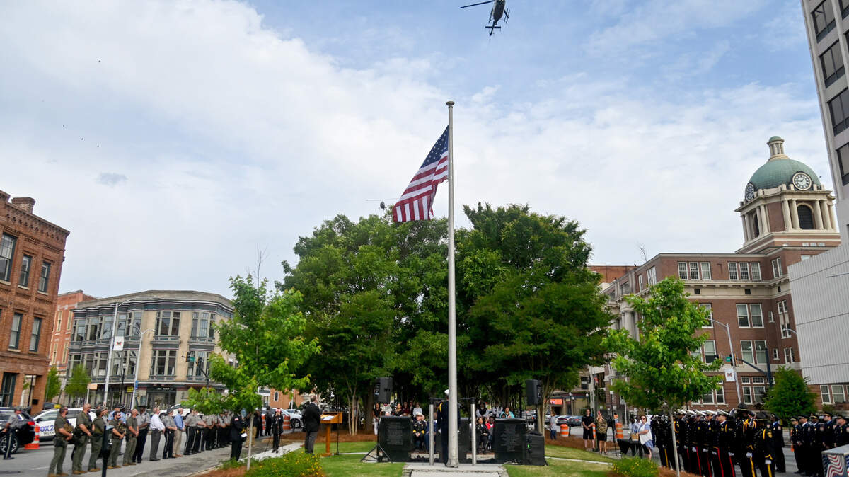 A pair of Georgia State Patrol helicopters perform a flyover of Public Safety Memorial Park in downtown Macon Friday, May 12, during a Peace Officer’s Memorial Day ceremony.