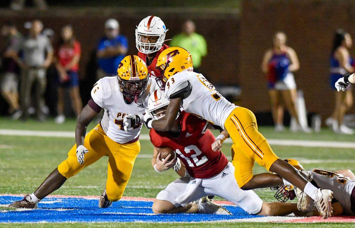 Veterans quarterback Jake Maxwell (12) is sacked by Perry defenders during the Panthers’ 49-41 victory Friday night.