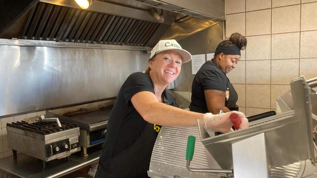 Jan Clark, co-owner of the new Baldinos Giant Jersey Subs in Warner Robins, slices meat to make a sub sandwich on opening day Tuesday, Dec. 17, 2024.