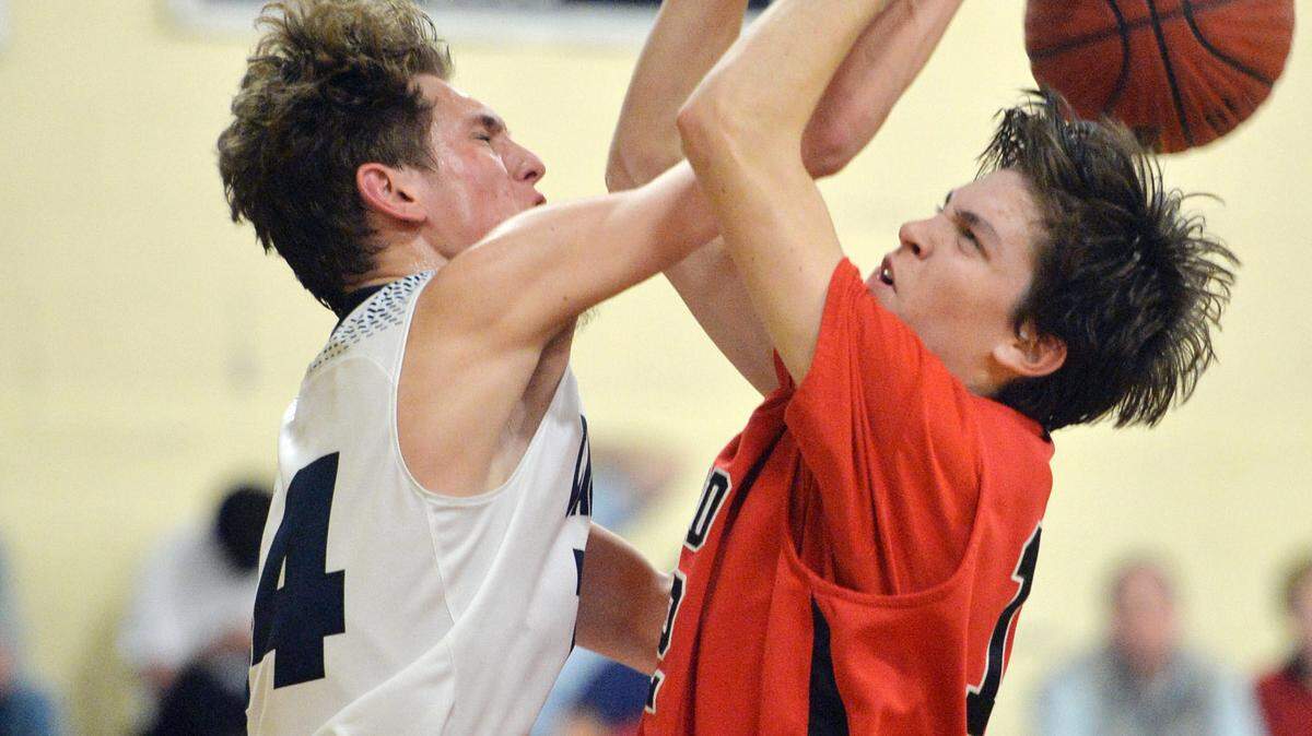 Mount de Sales' Adam Leverett (14) pushes back a shot by a driving Beck Muse (12) of FPD.