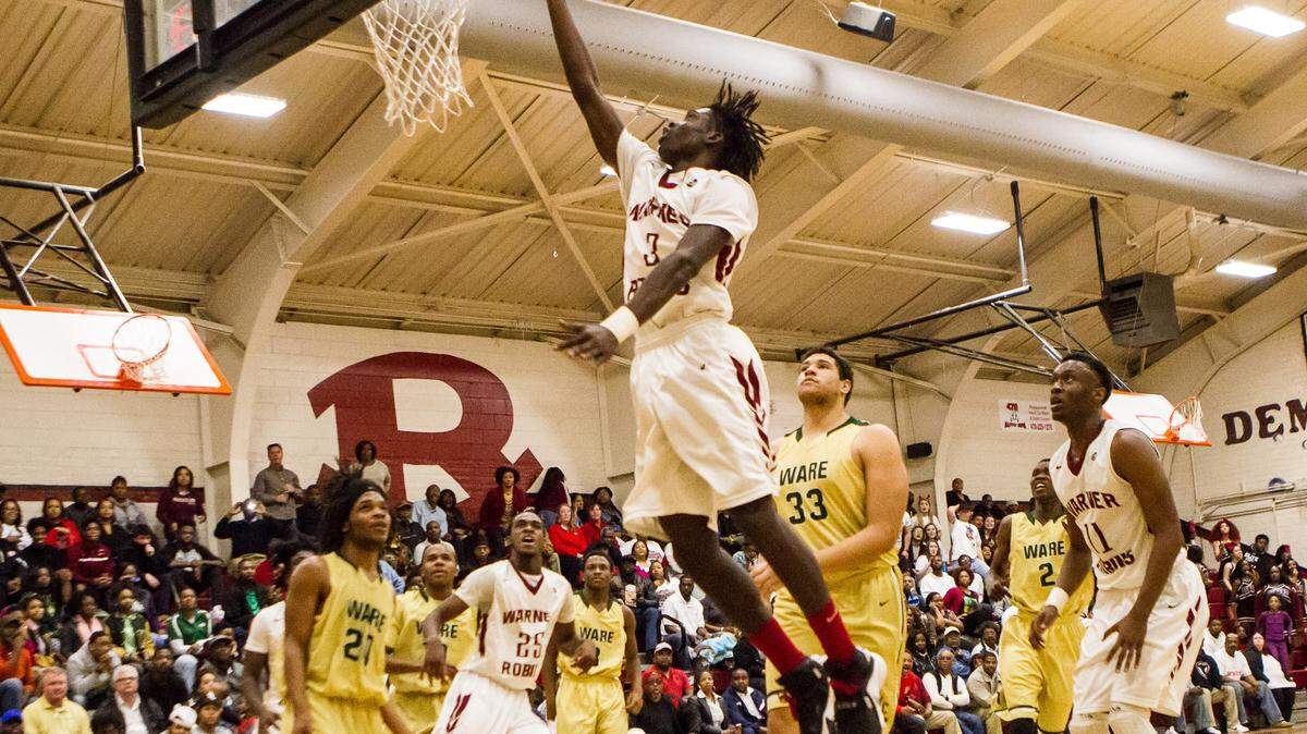 Warner Robins' Tracy King (3) goes up for a layup against Ware County on Wednesday during the first round of the GHSA Class AAAAA Tournament.