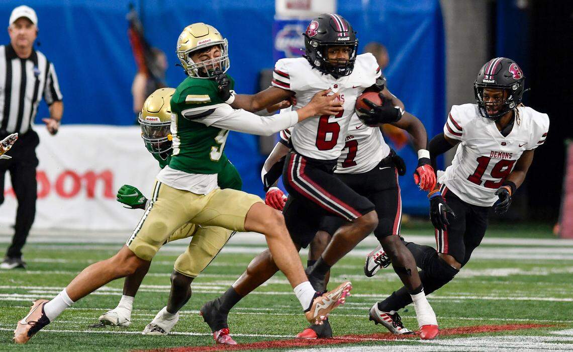 Warner Robins’ Cam Flowers (6) returns a kickoff during the Demons’ GHSA 5A championship game against Ware County Saturday in Atlanta.