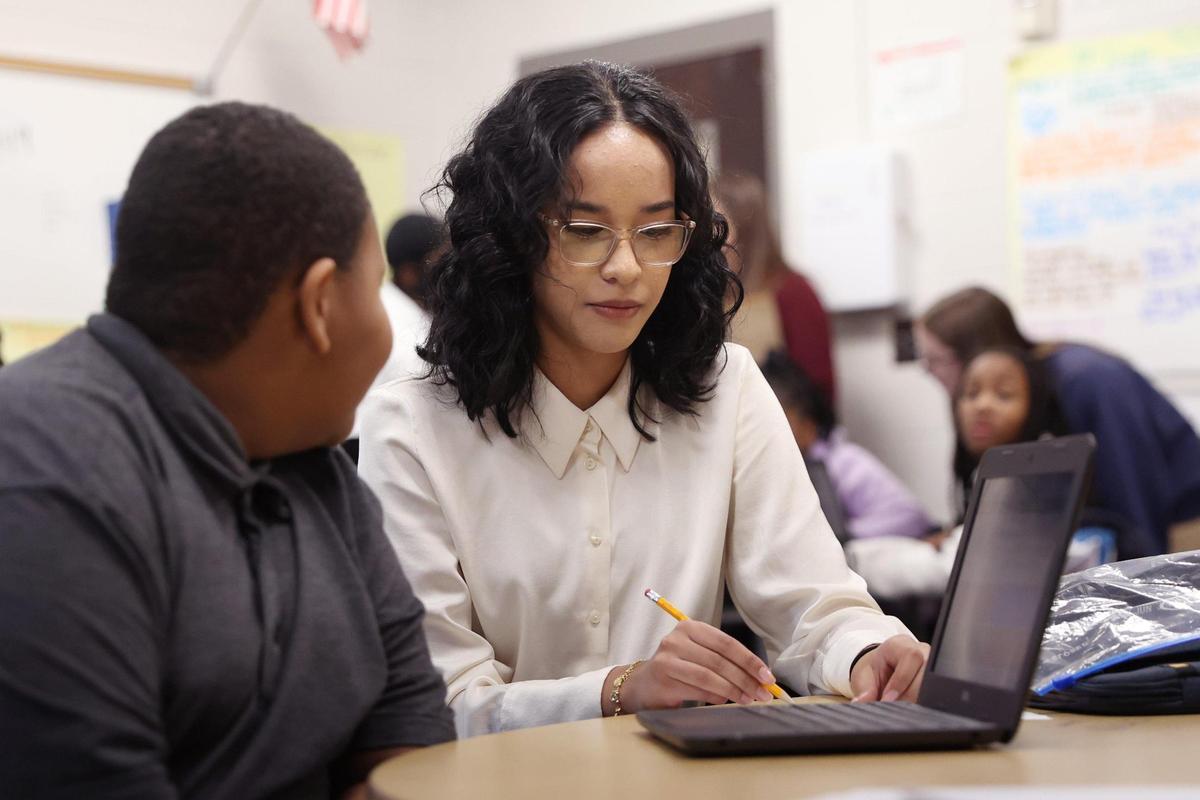 Hutchings Academy student Zoe Hunermand helps a student with an assignment in Montarrio Carter’s class at Ingram Pye Elementary School on Monday, Feb. 24, 2025, in Macon, Georgia. Hunermand is one of a number of students in Hutchings’ “Teaching as a Career” pathway that prepares high school students interested in teaching as well as fills the state’s teacher employee gaps.