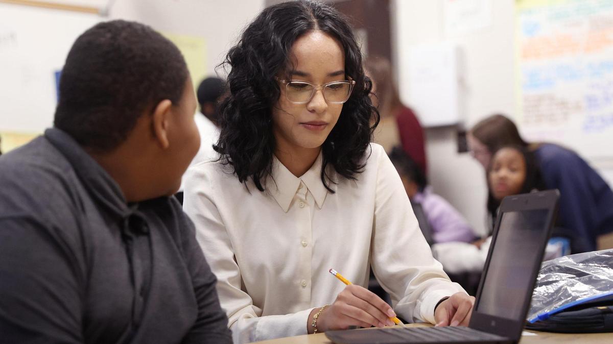 Hutchings Academy student Zoe Hunermand helps a student with an assignment in Montarrio Carter’s class at Ingram Pye Elementary School on Monday, Feb. 24, 2025, in Macon, Georgia. Hunermand is one of a number of students in Hutchings’ “Teaching as a Career” pathway that prepares high school students interested in teaching as well as fills the state’s teacher employee gaps.