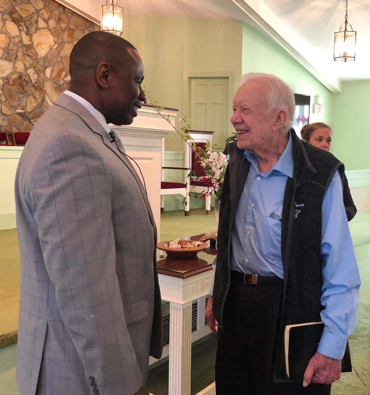 The Rev. Tony Lowden, left, greets former President Jimmy Carter at Maranatha Baptist Church in Plains, Ga. Lowden, of Warner Robins, was recently installed as pastor of the church, where Carter teaches Sunday school.