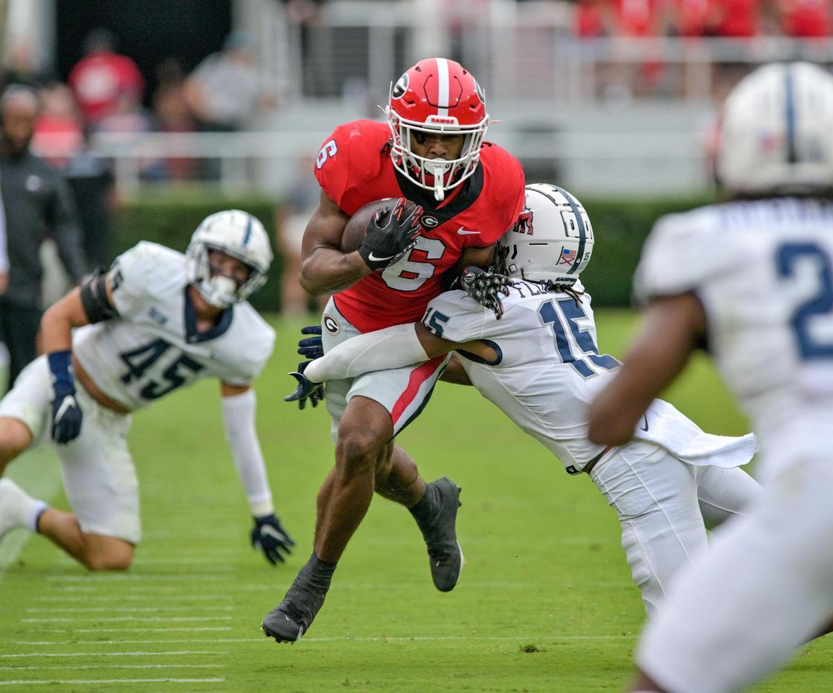 Georgia running back Kenny McIntosh (6) slips a tackle a heads into the red zone during the Bulldogs’ 33-0 win over Samford Saturday in Athens.