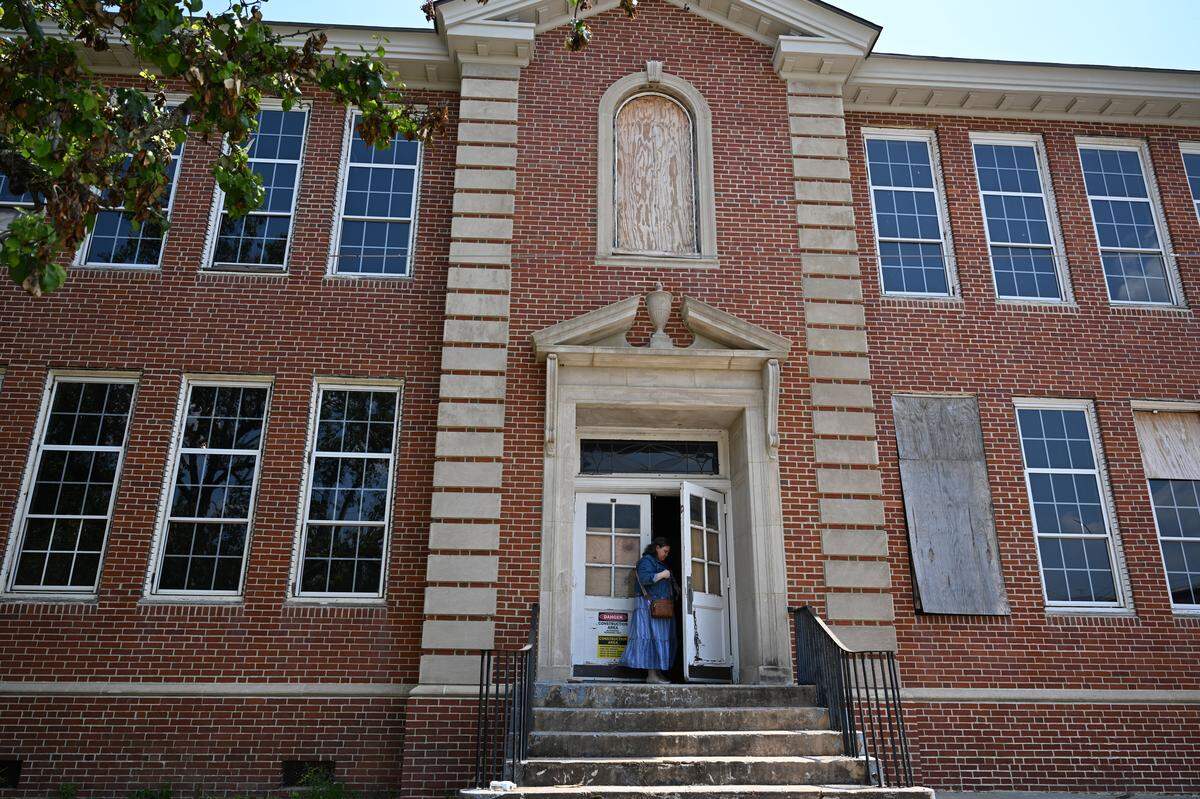 One Safe Place Macon Executive Director Sarah Schank locks the door to the former Virgil Powers School after a tour April 22, 2026, in Macon, Ga. The decades-old building is under renovation to become One Safe Place Macon, a family justice center that will house multiple agencies under one roof to better assist victims of abuse.