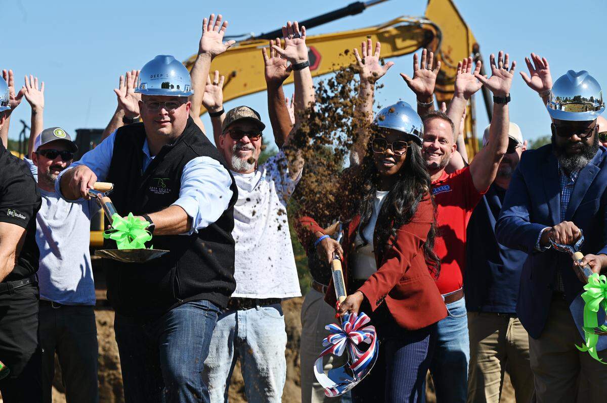 Deep South Construction owner Michael Ware (left) and City of Warner Robins mayor LaRhonda Patrick (right) throw dirt during a ceremonial ground breaking for eight new affordable housing townhomes on Wednesday, Sept. 10, 2025, in Warner Robins, Georgia. The project is the first city funded affordable housing development in Warner Robins through a $1.5 million Community HOME Investment Program (CHIP) 2024 grant. 
