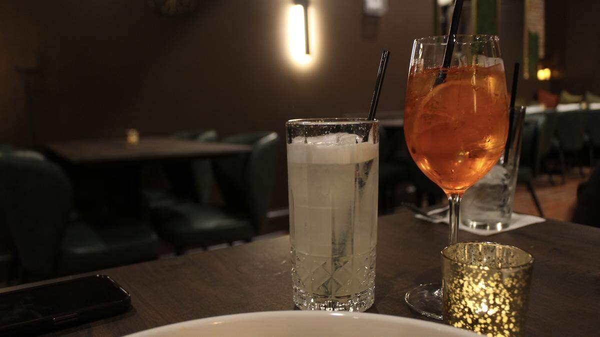 A Rainbow Gin Fizz without the rainbow-colored syrup (left), and an Aperol spritz are served at Parish on Cherry.