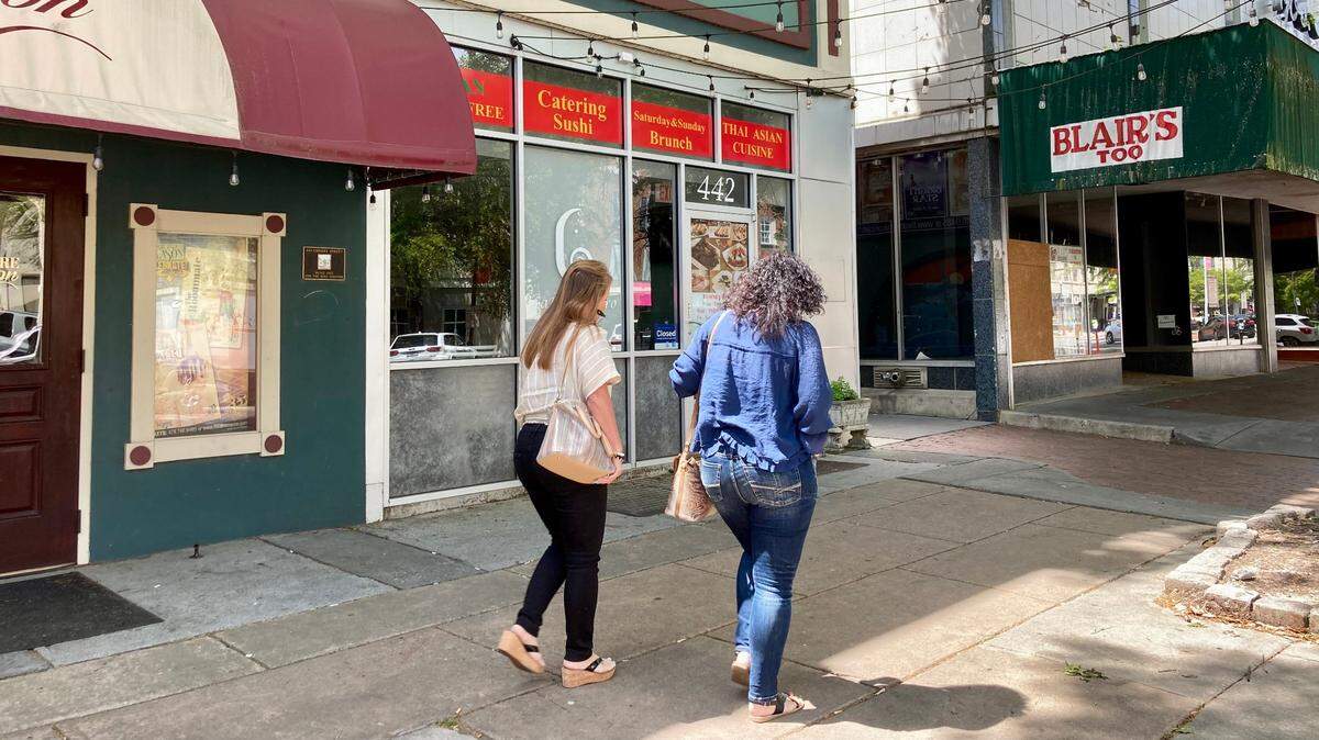 People walk by Ladda Bistro at 442 Cherry St. in downtown Macon.