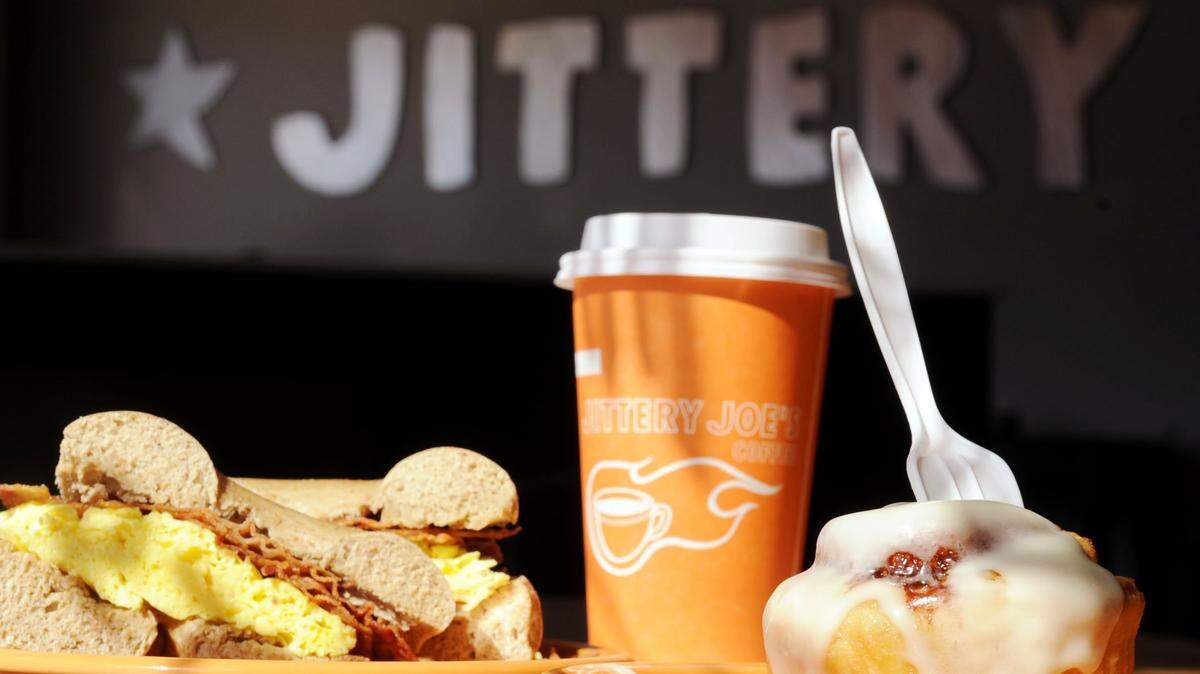 Cinnamon roll and wheat bagel with egg and bacon and cup of coffee at Jittery Joe's.