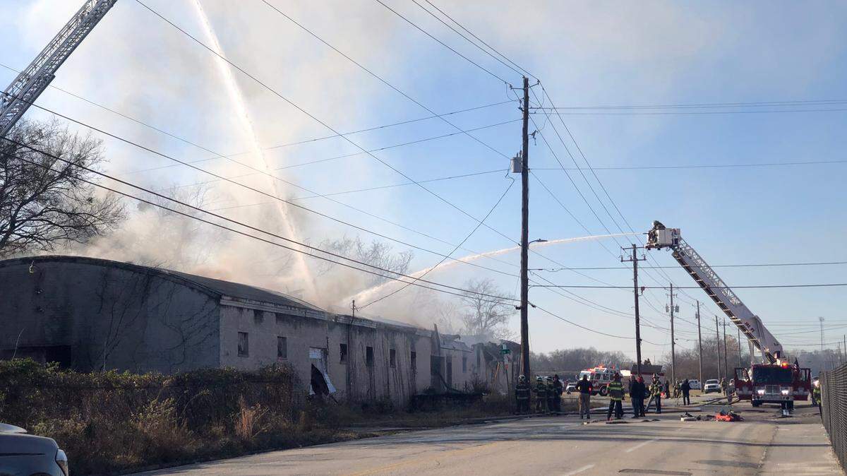 Firefighters work to extinguish flames at 720 5th St. in downtown Macon Thursday morning. The first call about the fire came in just after 7:30 a.m.