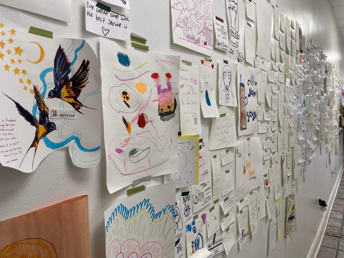 A collage of notes of appreciation, love and support from coffee shop guests fills a wall at Little Light Coffee Co. in Warner Robins.