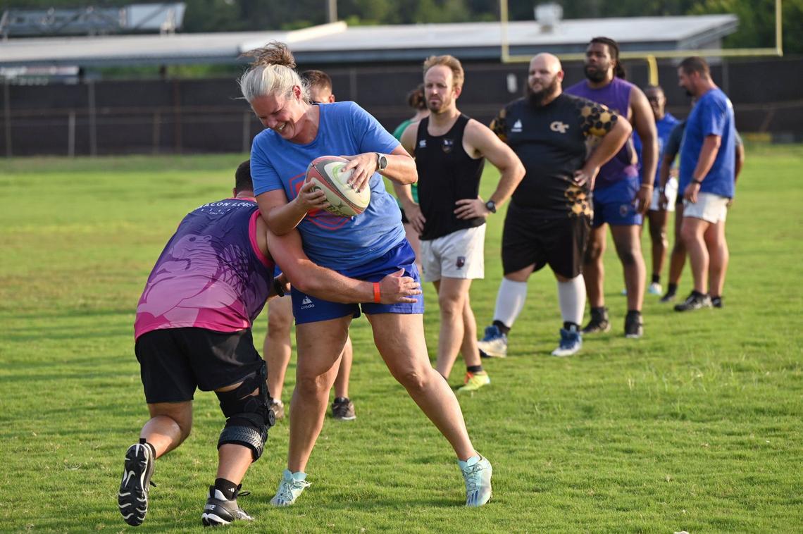 Erin Henry runs the ball during a defensive drill at Macon Love Rugby practice on Thursday, Aug. 8, 2024, at Central City Park in Macon, Georgia. Macon’s amateur rugby team is expanding by competing with an all-female team at a summer competition this weekend.