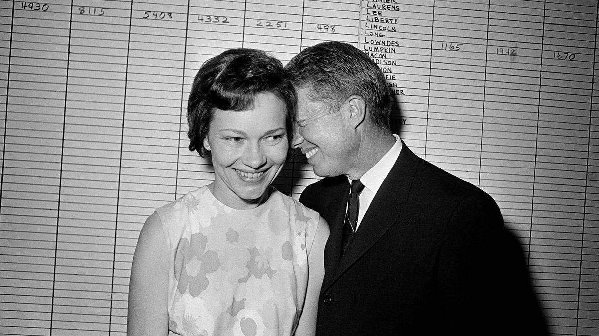 In this 1966 file photo, then Georgia State Sen. Jimmy Carter hugs his wife, Rosalynn, at his Atlanta campaign headquarters.