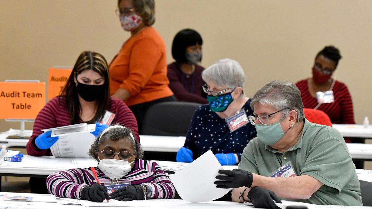JASON VORHEES/THE TELEGRAPH Macon, GA, 11132020 Poll workers count votes by hand at the Macon-Bibb County Board of Elections Friday.
