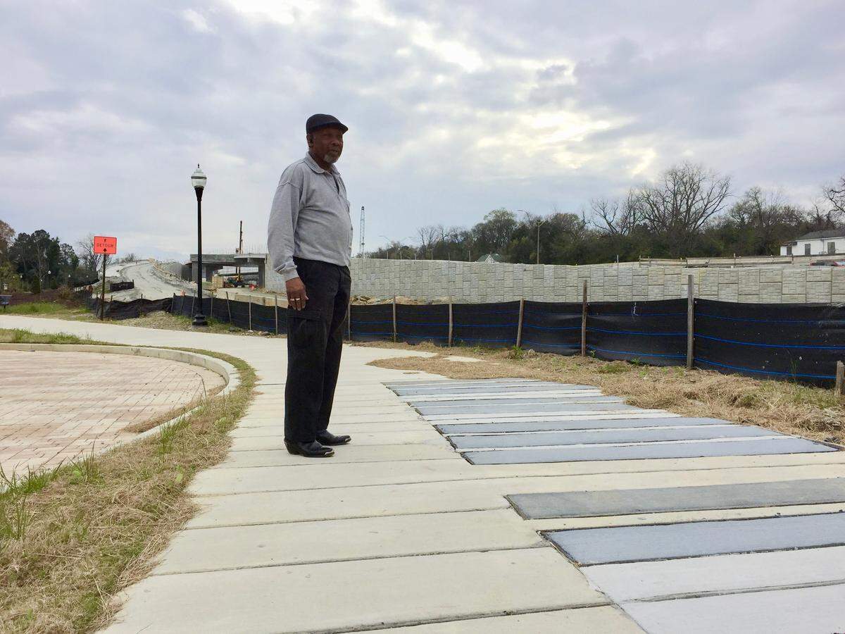 Pleasant Hill resident Peter Givens stands on a set of paved piano keys where “Little” Richard Penniman’s childhood home once stood, before the I-16/I-75 interchange split the neighborhood in two. When the Georgia Department of Transportation announced it would expand the freeway, Givens helped to draft a mitigation plan that took both GDOT’s and residents’ concerns into account.