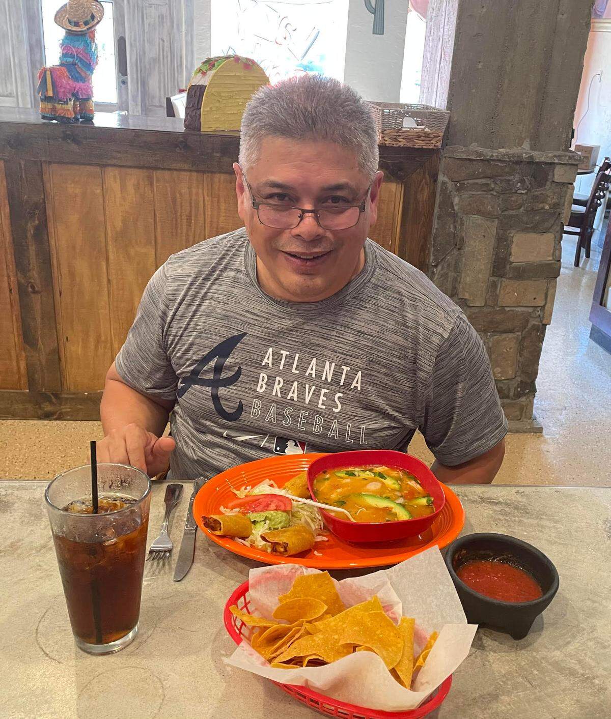 Jose Dancel enjoys the Sopa de Pollo (chicken soup) with two taquitos at the Lazy Donkey, a new Mexican restaurant in downtown Macon. He was setting up the point of sale system for the restaurant.