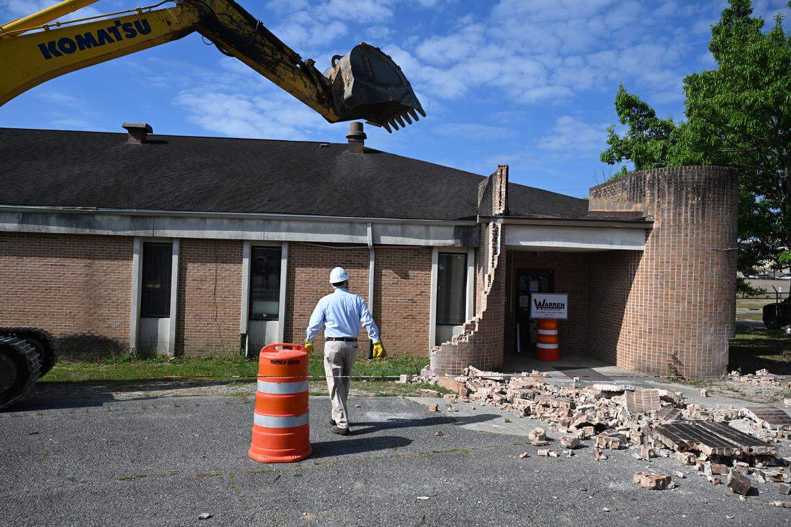 Bibb County Sheriff David Davis walks toward the excavator after the first piece of the James F. Higgins Memorial Building fell on Thursday, April 16, 2026. The demolition began the first phase of the Bibb County Jail renovation.