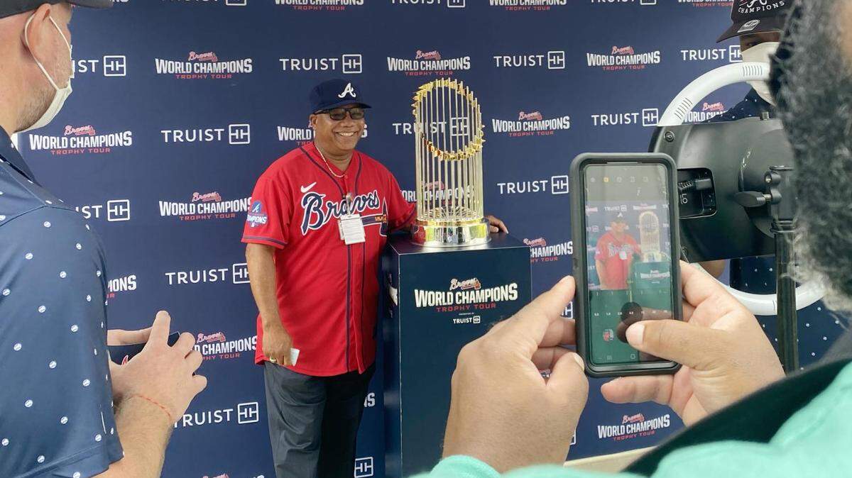 John Rawls, Sr. poses with the Braves World Series Commissioner’s Trophy in downtown Macon. “It means the world to me,” Rawls said.