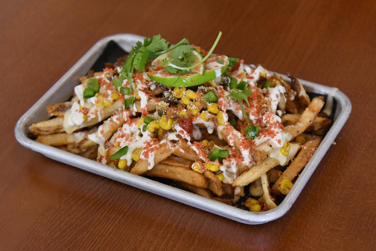 Street corn fries sit on a table in Ocmulgee Brewpub on Wednesday, July 10, 2024, in downtown Macon, Georgia. Ocmulgee Brewpub was one of 20 locations in the 3rd annual Downtown Macon French Fry Fight, where each participating restaurant creates a unique french fry special for the day in competition with other local restaurants.