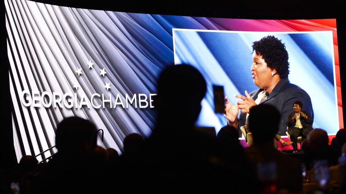 Georgia  gubernatorial candidate Stacey Abrams, right, answers questions during her appearance at the Georgia Chamber of Commerce luncheon in August.