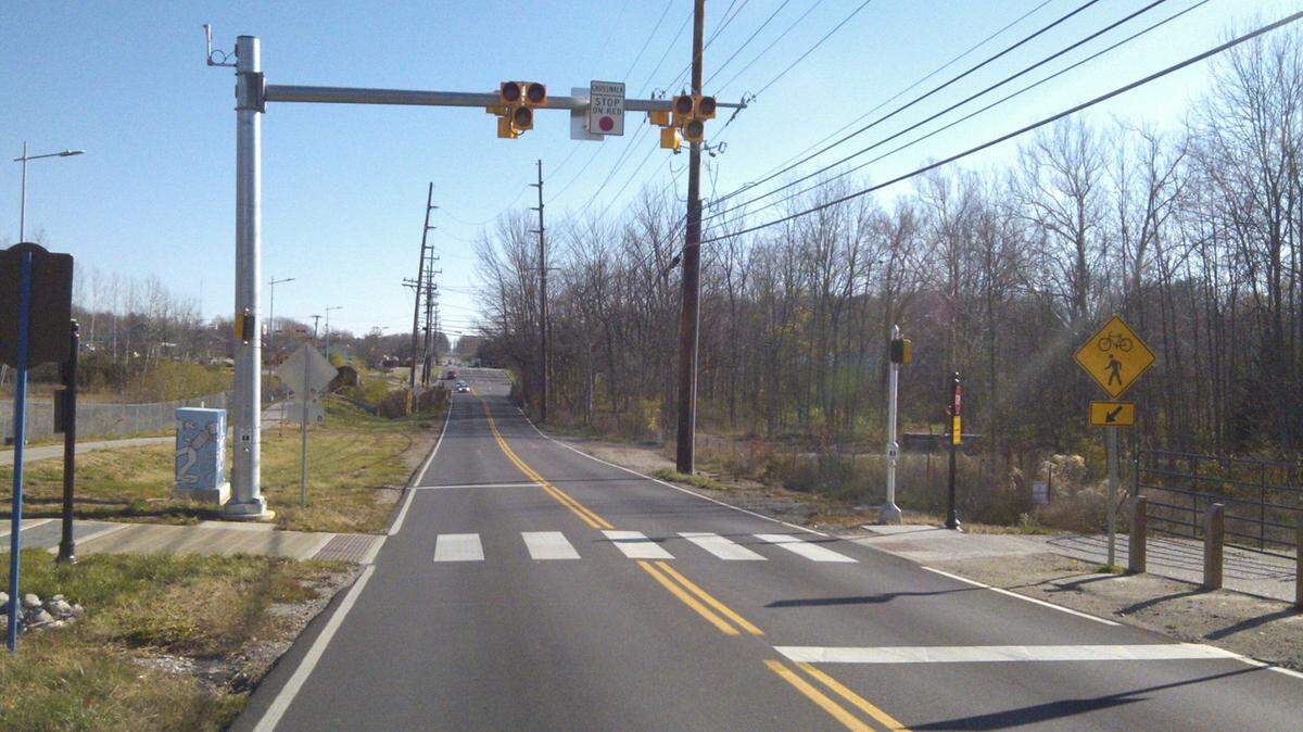 A HAWK beacon is installed over a crosswalk.