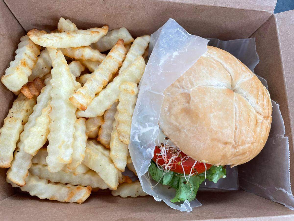 The Verus power burger, an oat patty topped with sprouts, lettuce, tomato and onions and served with freshly sliced fries, at Verus Vine Plant Based Kitchen in Byron.
