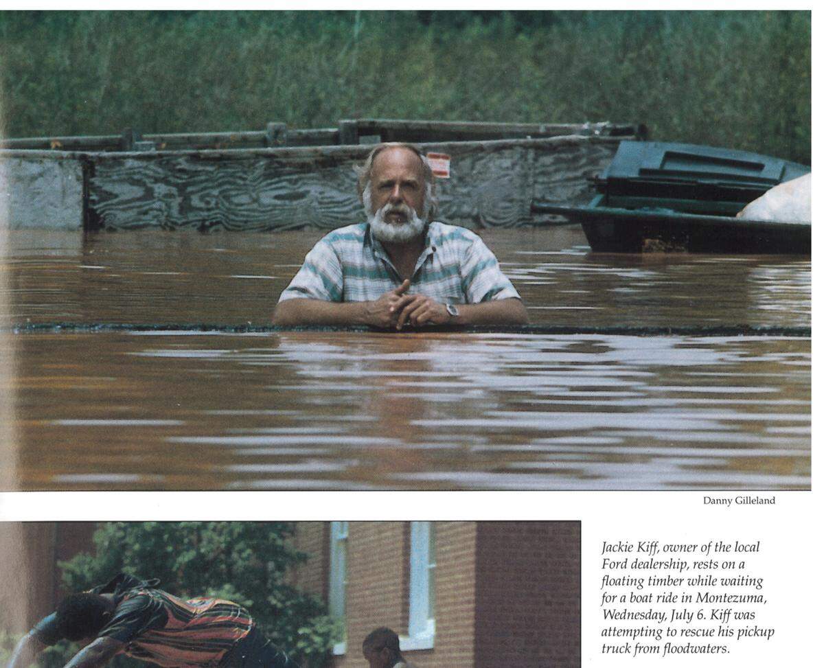 Jackie Kiff, owner of a local Ford dealership in Montezuma, waiting for a boat ride on Wednesday, July 6, 1994. Kiff was out trying to rescue his pickup truck from floodwaters