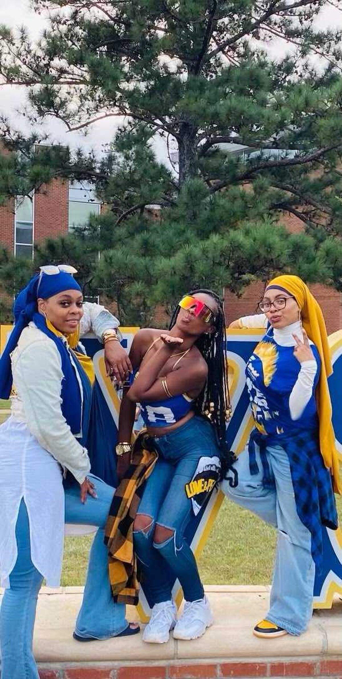 Late Fort Valley State University student Laila Ali Gadson (middle) poses with her mother, Kiana Ali (left) and Anisah Granger (right) while sporting FVSU colors.