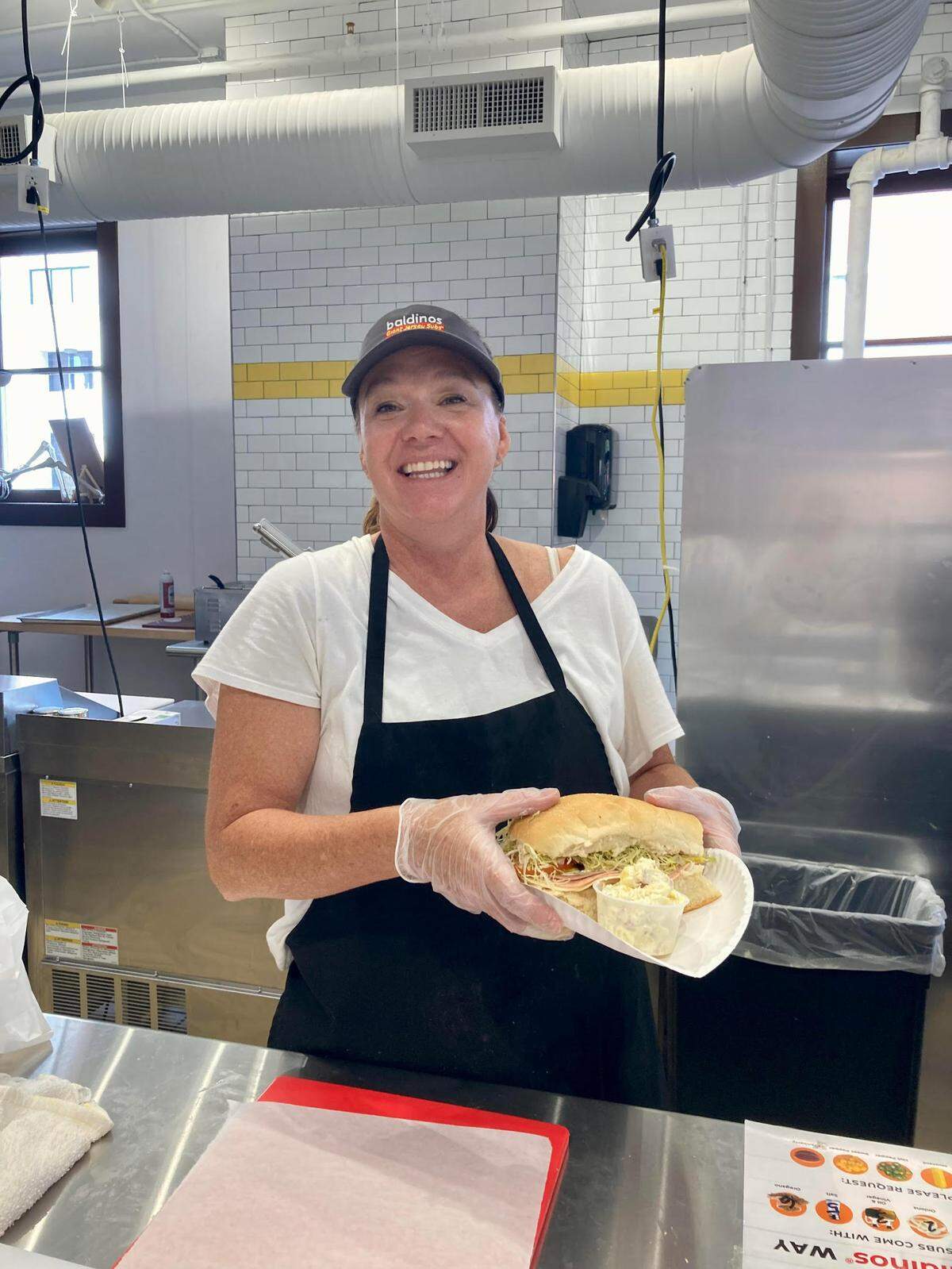 Co-owner Jan Clark serves up a sub at Baldinos Giant Jersey Subs in downtown Macon.