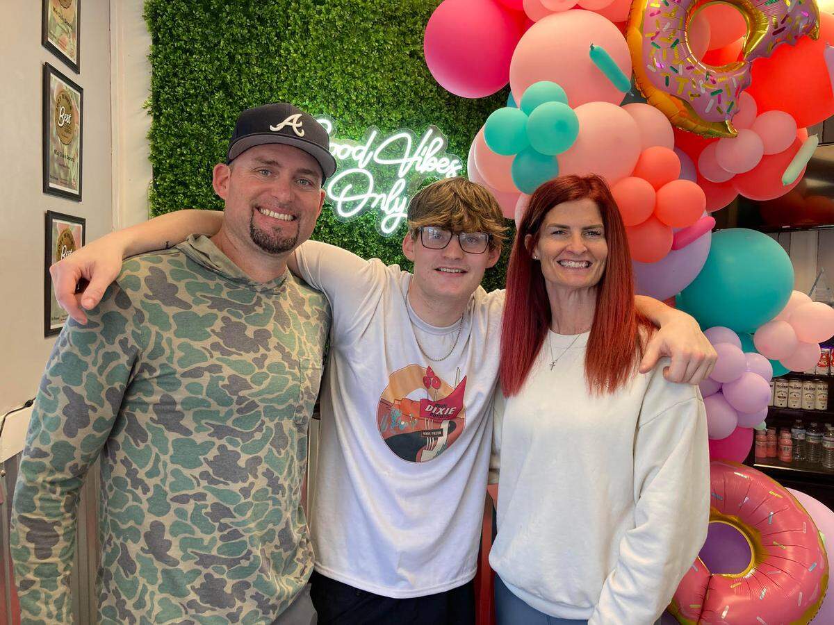 New owners Kevin and Jaimi Norrell of Mini Dixie Donuts in Warner Robins with their 18-year-old son, Kaden Norrell, middle. Kaden Norrell will serve as the chief doughnut maker.
