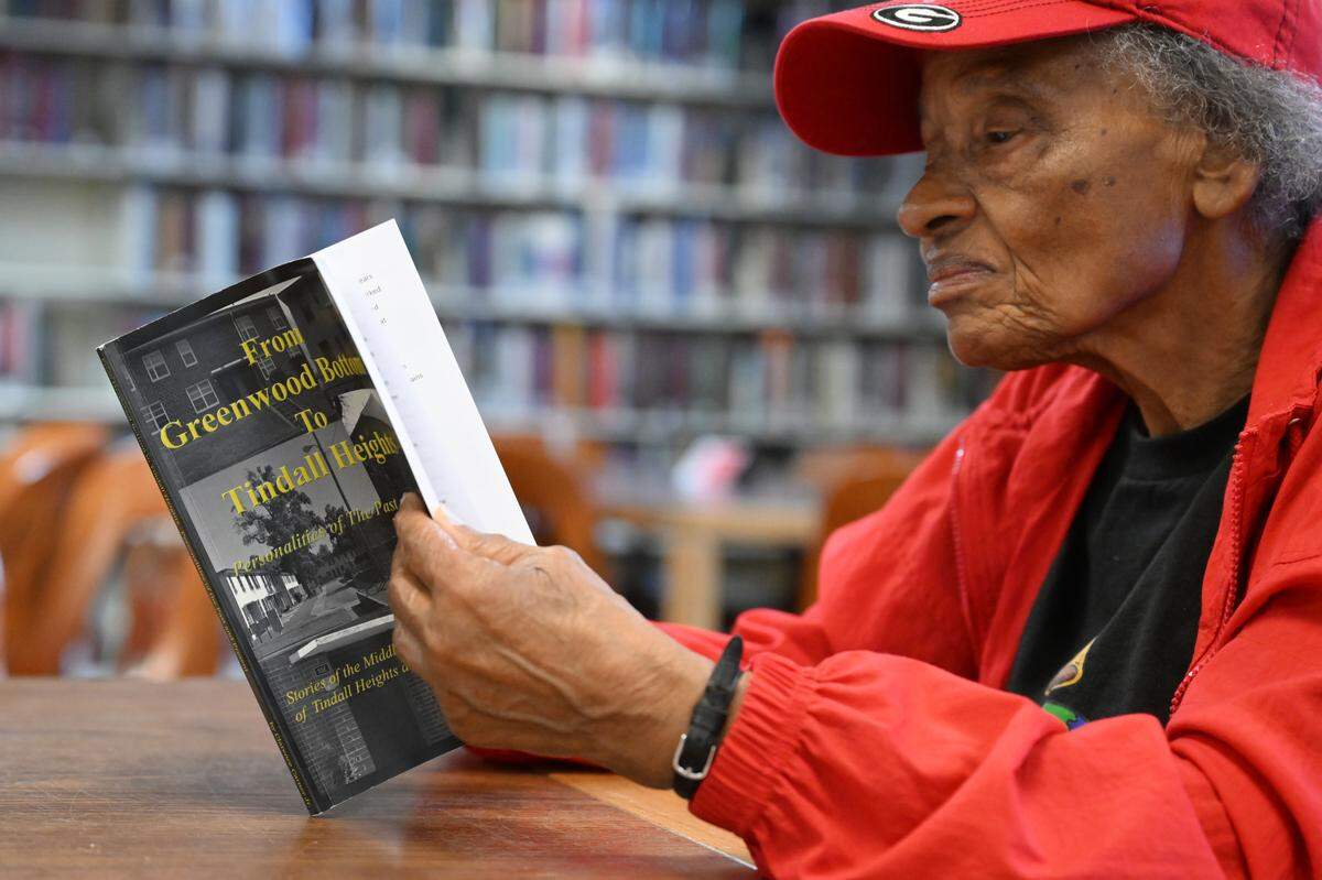 Barbara Tolliver Rodgers, 86, flips through “From Greenwood Bottom to Tindall Heights: Personalities of the Past and Present” during a committee meeting of the African-American History Committee on Tuesday, Feb. 17, 2026, at the Washington Memorial Library in Macon, Georgia. Rodgers spoke on her own family history during the meeting and has an archive room in her home.