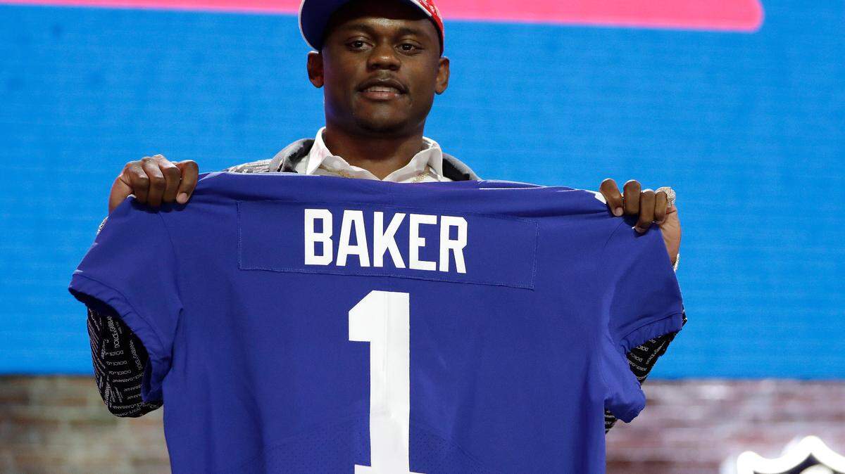 In this April 25, 2019, file photo, former University of Georgia defensive back DeAndre Baker poses with his new jersey after the New York Giants selected him in the first round at the NFL football draft in Nashville, Tennessee. Baker was charged with four accounts of robbery on Friday.