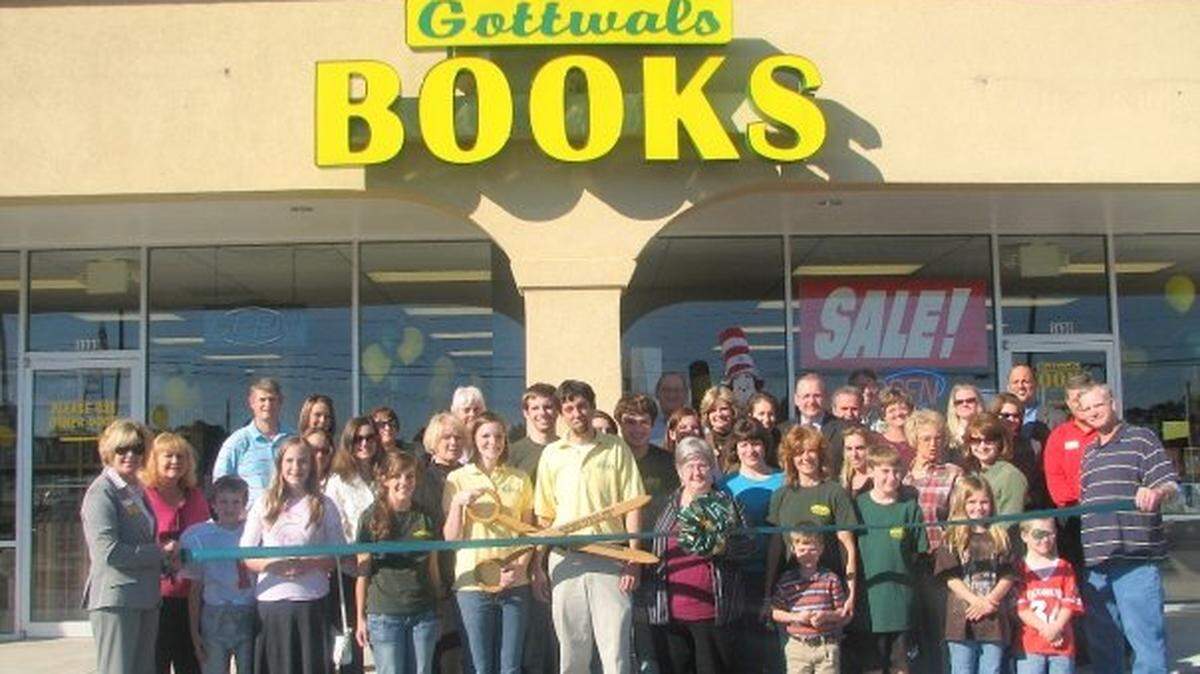 In an updated photo, people attend a ribbon cutting for one of the four Gottwals Books located in Middle Georgia.
