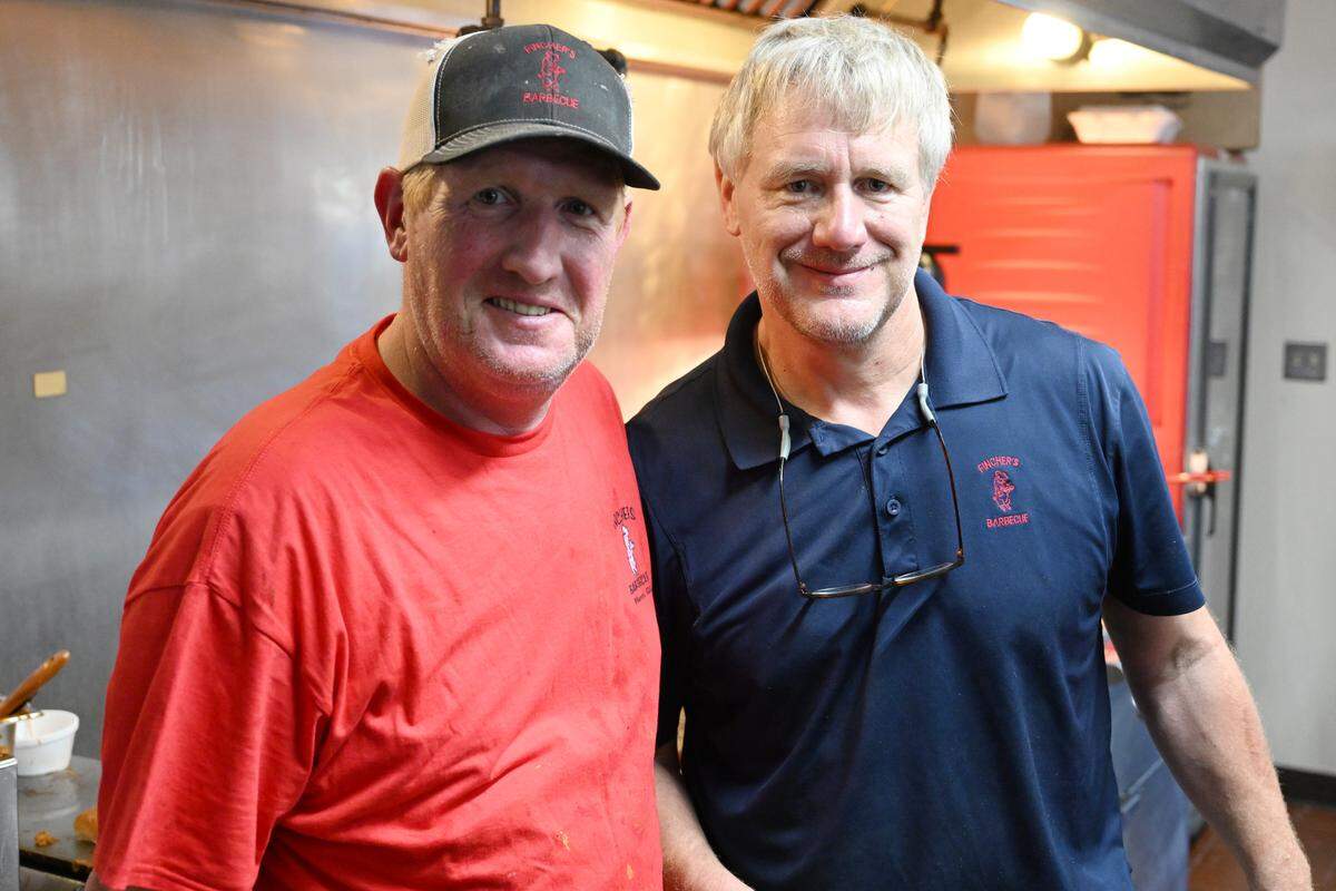 Fincher’s Barbecue co-owners Jake Fincher, left, and his brother and co-owner Doug Fincher inside the kitchen of the new Warner Robins location on Friday, May 15, 2026 in Warner Robins, Georgia. The historic multi-generational family-owned business opened its first restaurant in Macon in 1935.